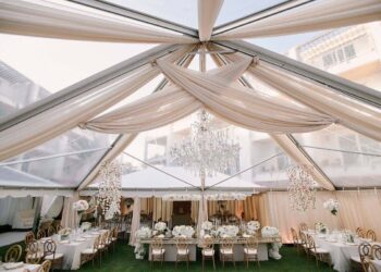 Asymmetrical ceiling drape champagne sheer tent wedding reception rental quest events nashville