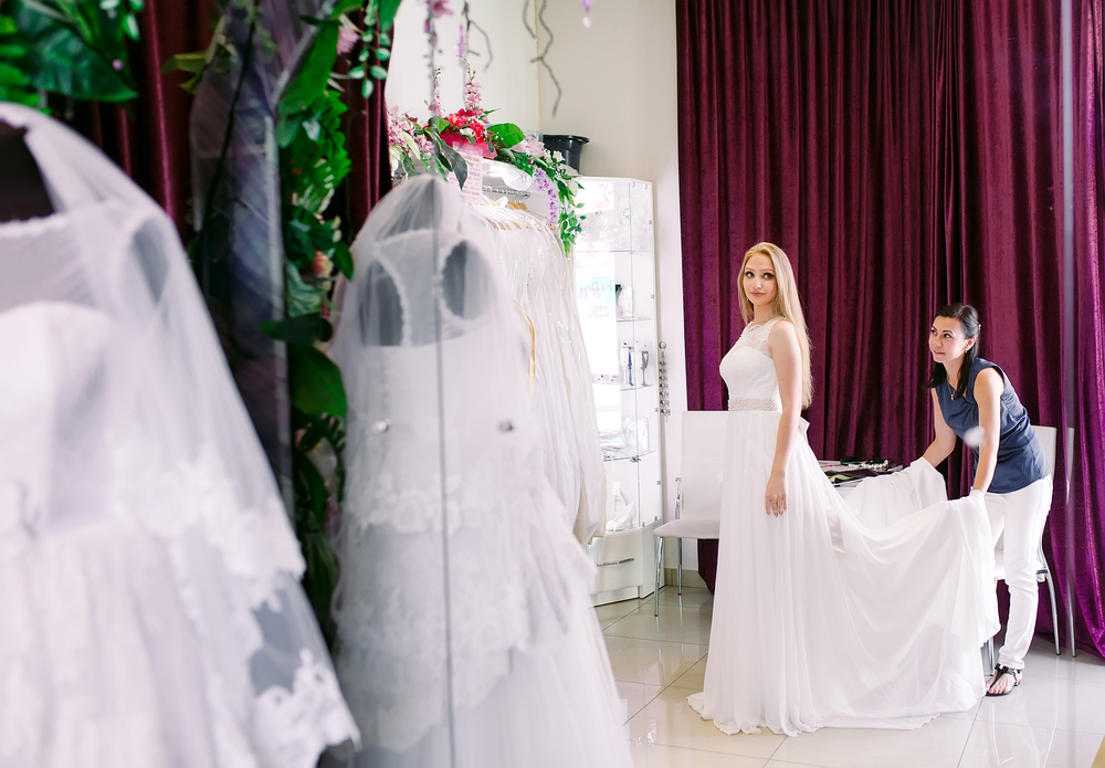 Female trying on a wedding dress in a shop